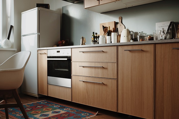 Place an oven inside cabinet in the kitchen